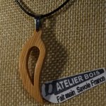 pendant feather or curved leaf made of waxed meleze wood handmade ethical jewelry nature