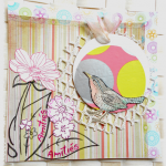 Carte d'amitiés  en scrap oiseau dans son nid de fleurs suspendu sur fond multicolore rose, jaune, fris graphique