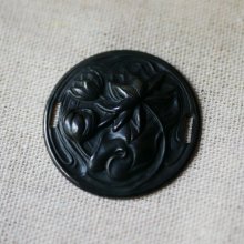 Water lily medallion in black metal relief with side ties 
