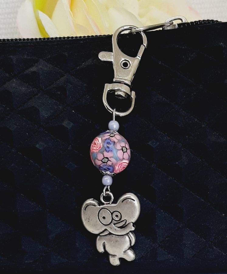 silver keychain with stylized elephant humor and handmade pink and purple bead