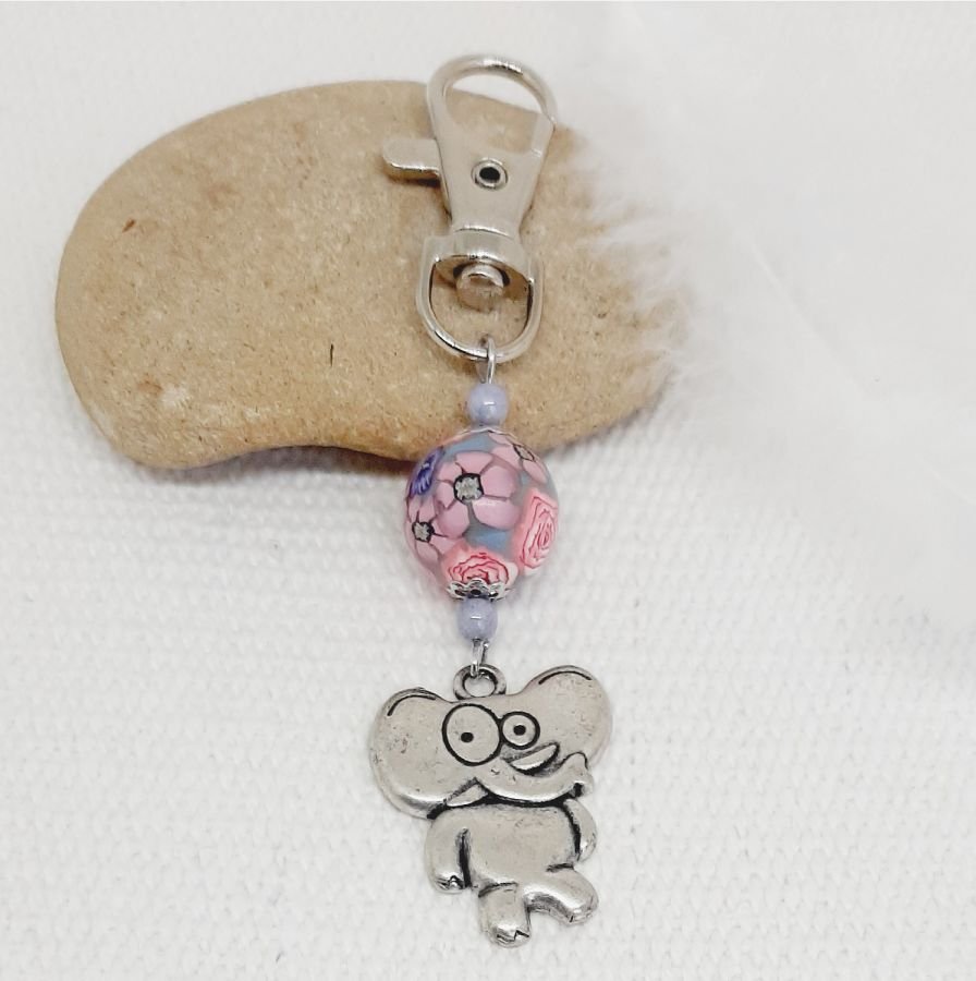 silver keychain with stylized elephant humor and handmade pink and purple bead