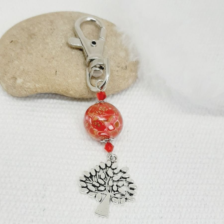 silver keychain with tree of life symbol and handmade red and gold bead