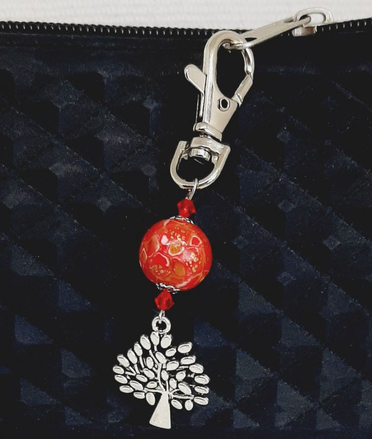 silver keychain with tree of life symbol and handmade red and gold bead