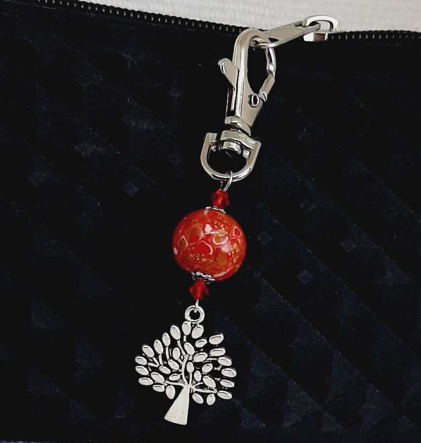 silver keychain with tree of life symbol and handmade red and gold bead