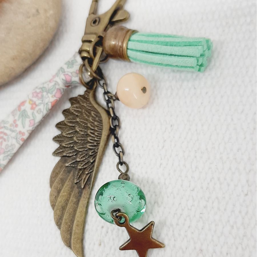 Keychain or purse jewel with angel wing pendant in soft pastel colors