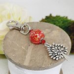 silver keychain with tree of life symbol and handmade red and gold bead