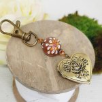 pedentific keychain photo holder and bead in brown polymer clay and white floweraet 