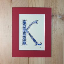 Illuminated letter K with interlacing