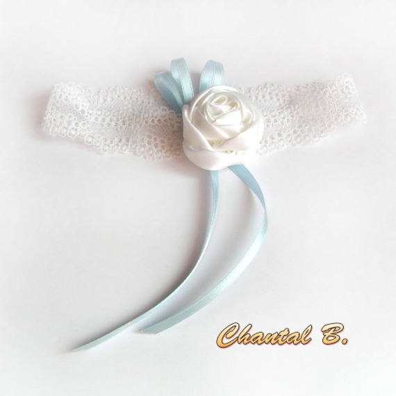 white lace wedding garter with satin flower and blue ribbon