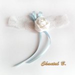 white lace wedding garter with satin flower and blue ribbon