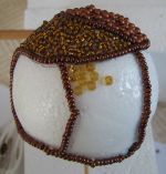 gluing seed beads onto the ball