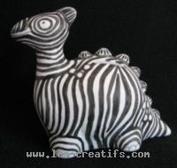 Ceramic dinosaur painted as a zebra