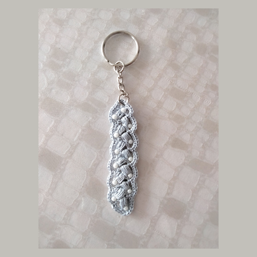Grey and white key ring with strap