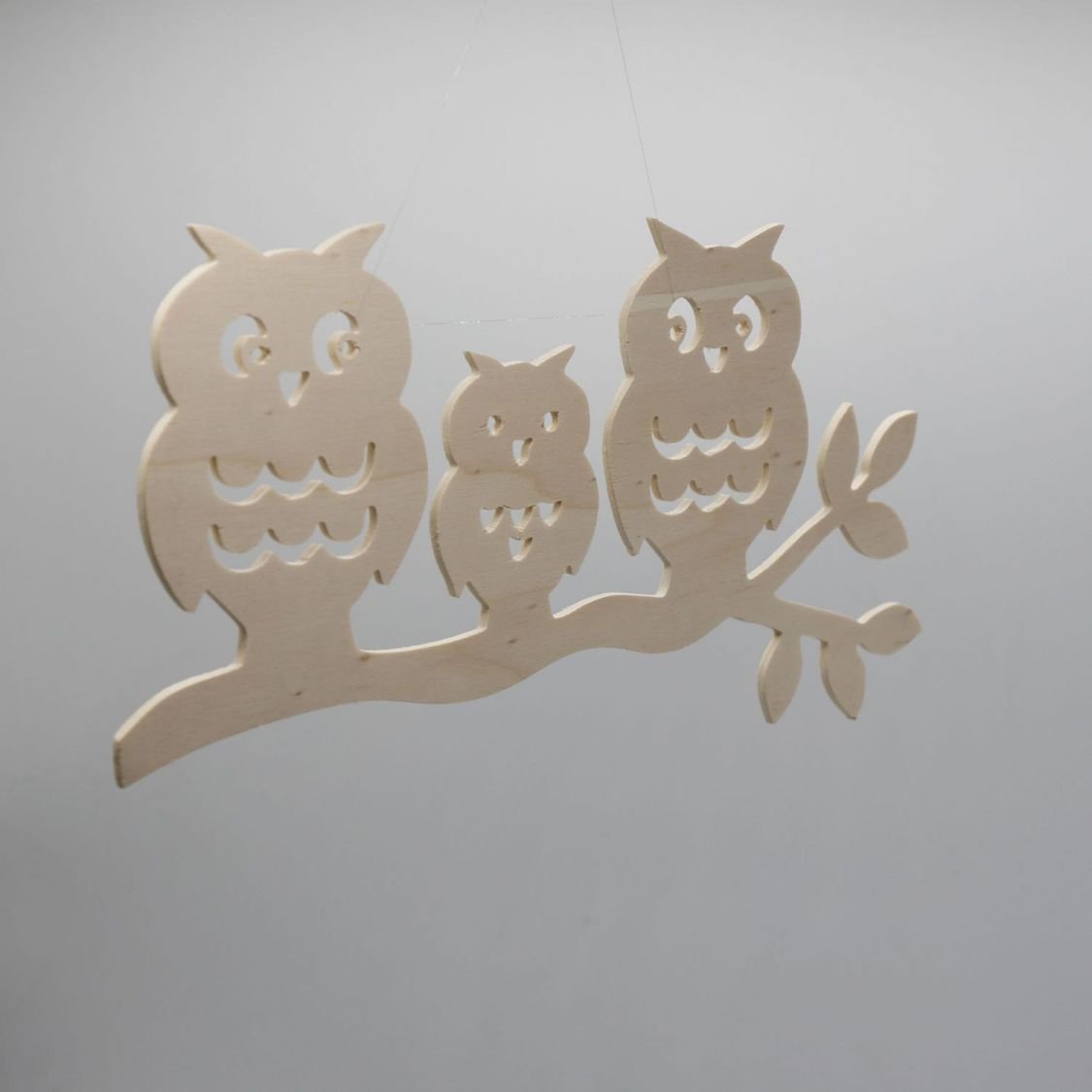  3 owls perched on a branch