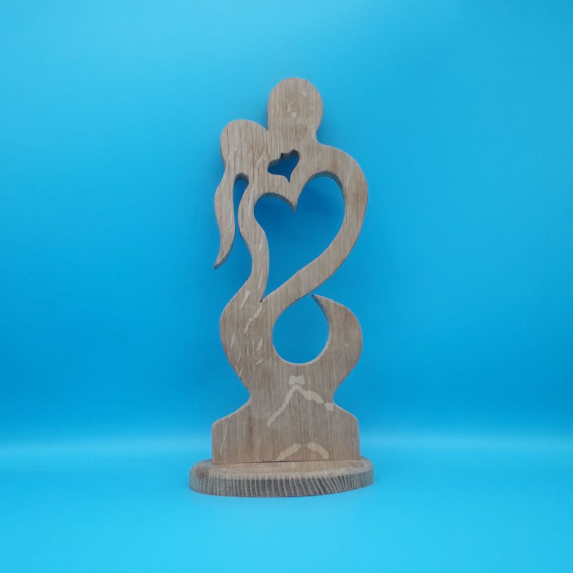 Couple of lovers embraced in solid oak