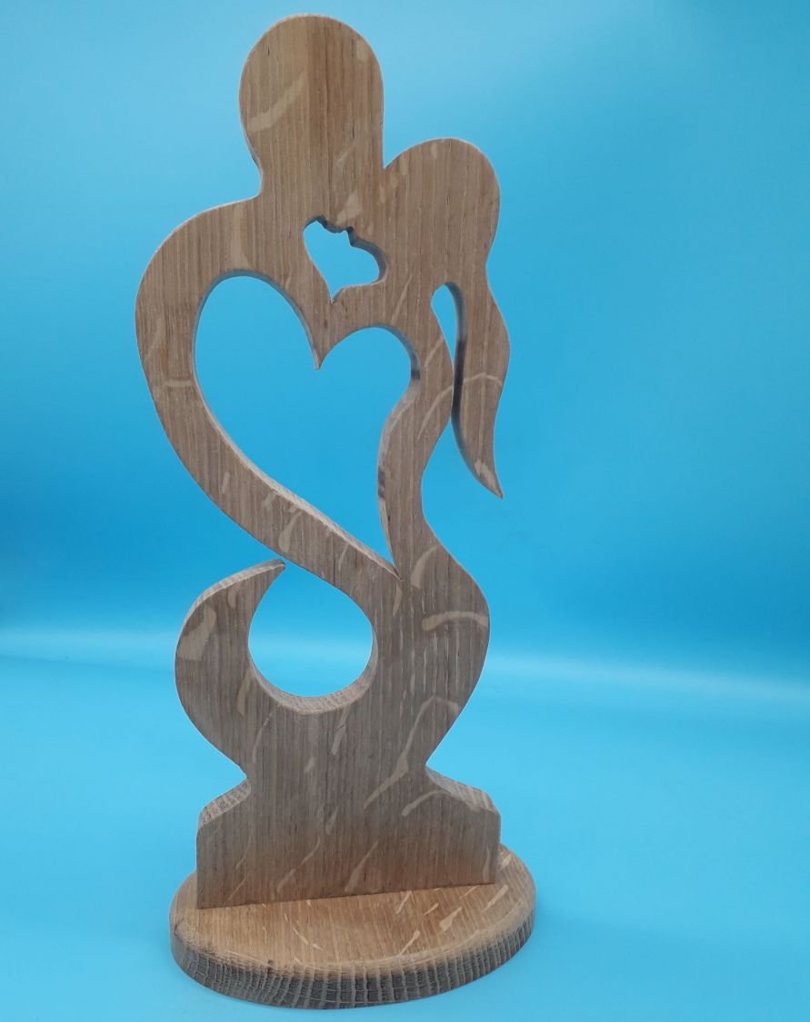 Couple of lovers embraced in solid oak