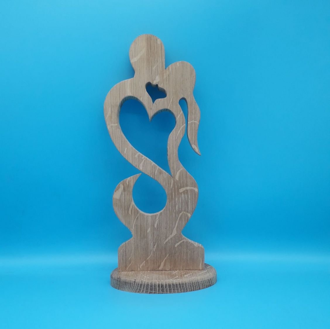 Couple of lovers embraced in solid oak