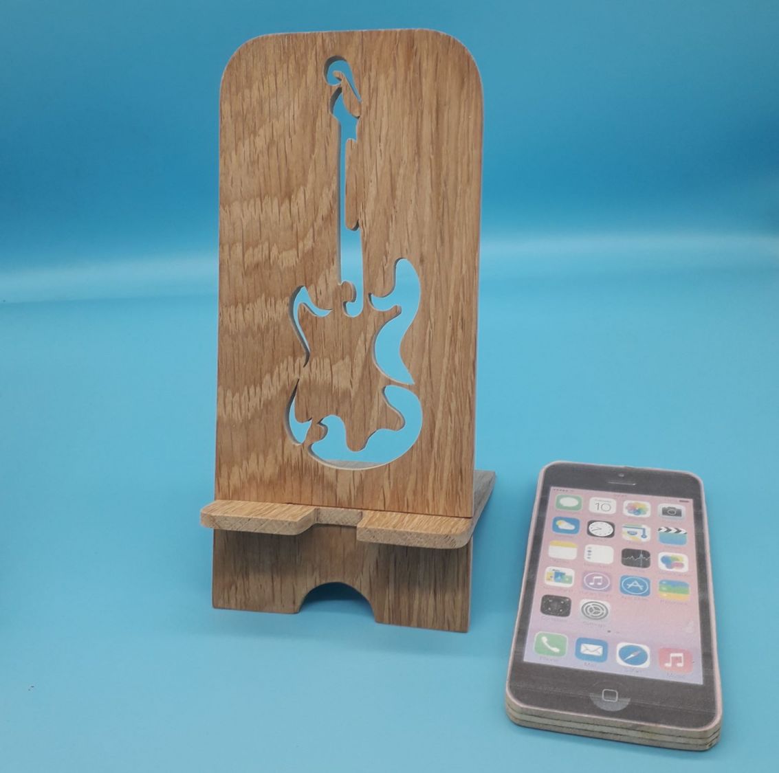 Vertical cell phone holder with guitar motif