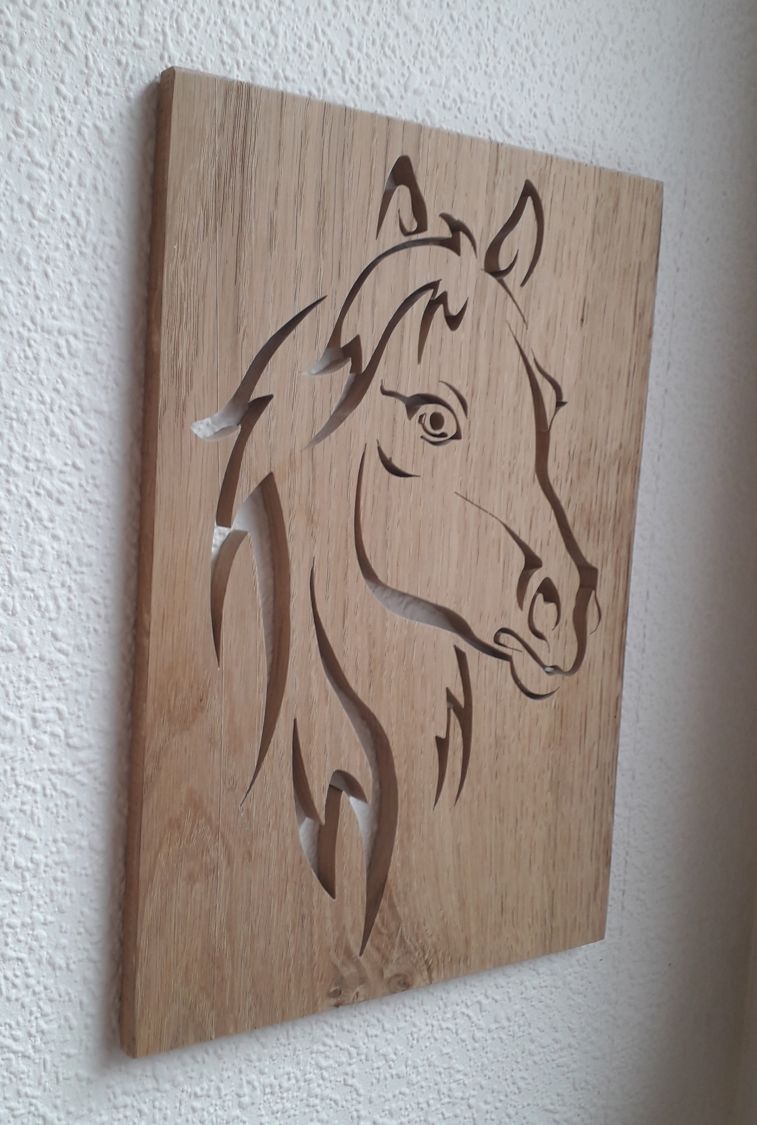 Stylized horse head, cut out of an oak panel