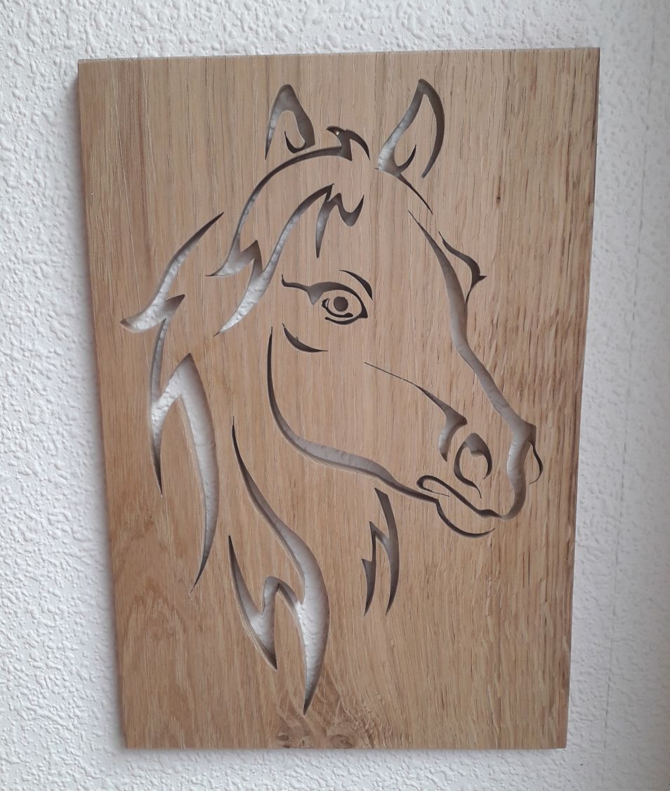 Stylized horse head, cut out of an oak panel