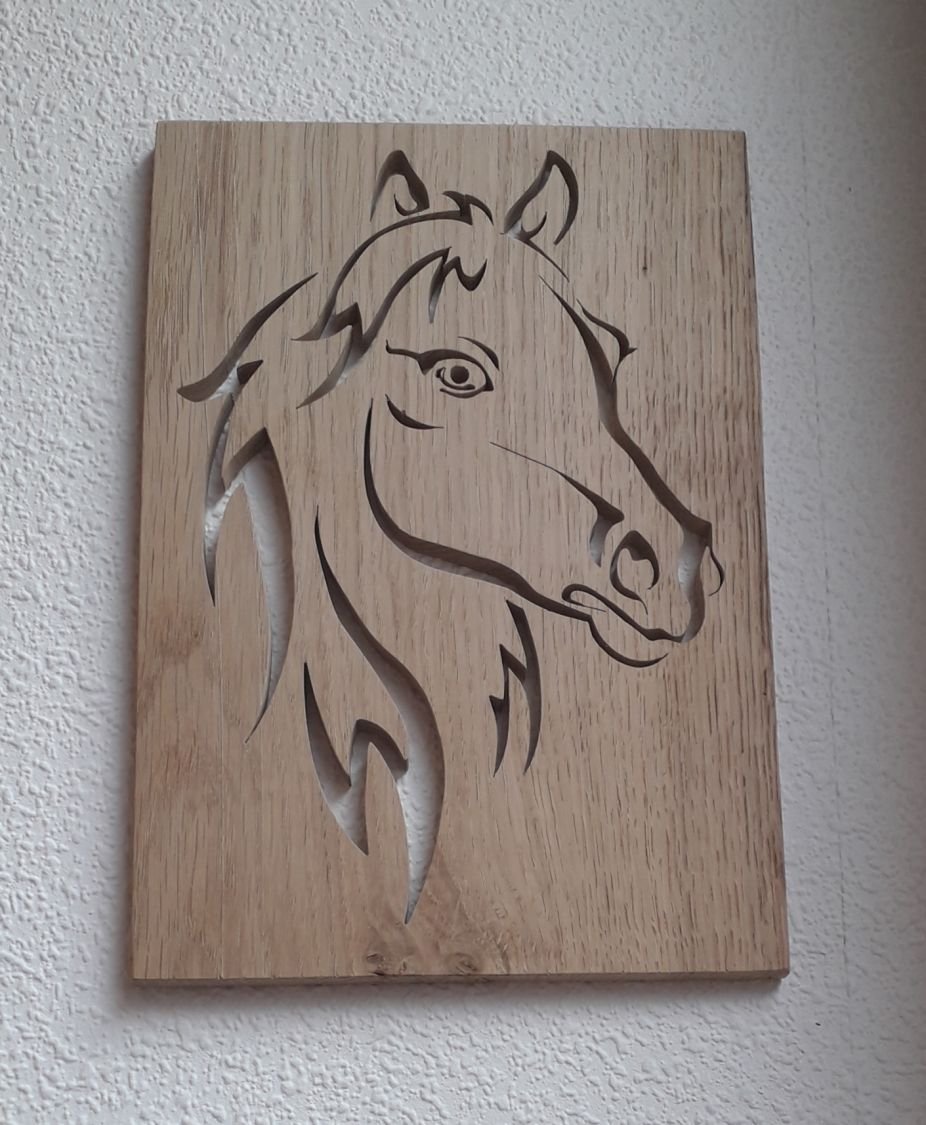 Stylized horse head, cut out of an oak panel