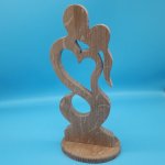 Couple of lovers embraced in solid oak