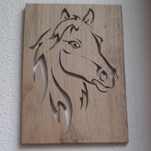 Stylized horse head, cut out of an oak panel