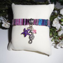 Colorful fabric bracelet with seahorse and purple starfish tassels