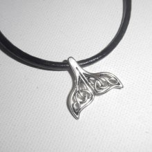Pendant openwork dolphin tail lucky metal on black leather