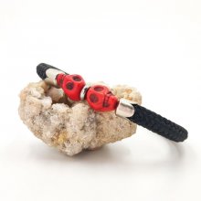Double skull and crossbones bracelet with red stones on black rope