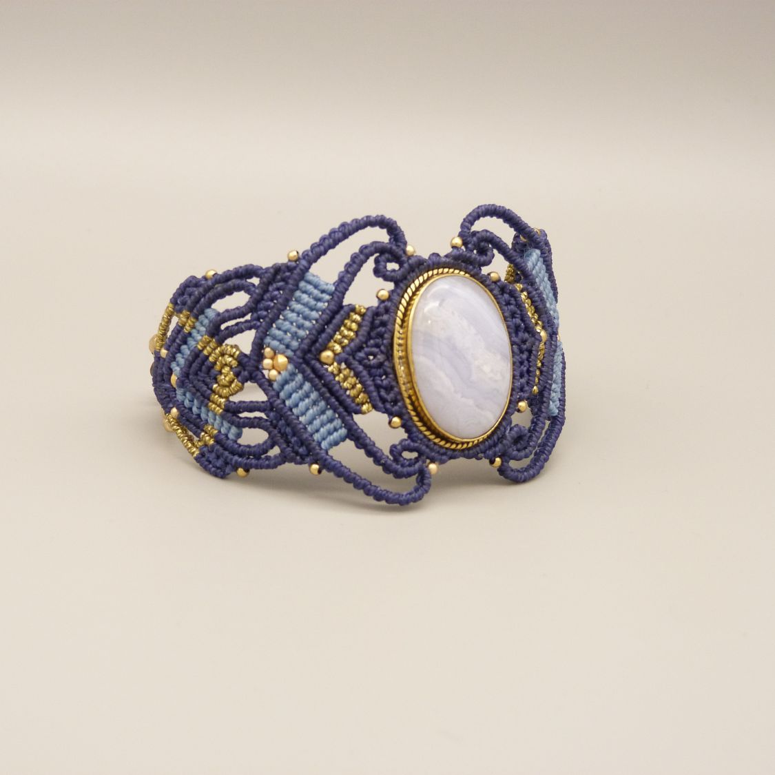 Midnight blue micro-macramé bracelet with a ribbon agate set in gold metal