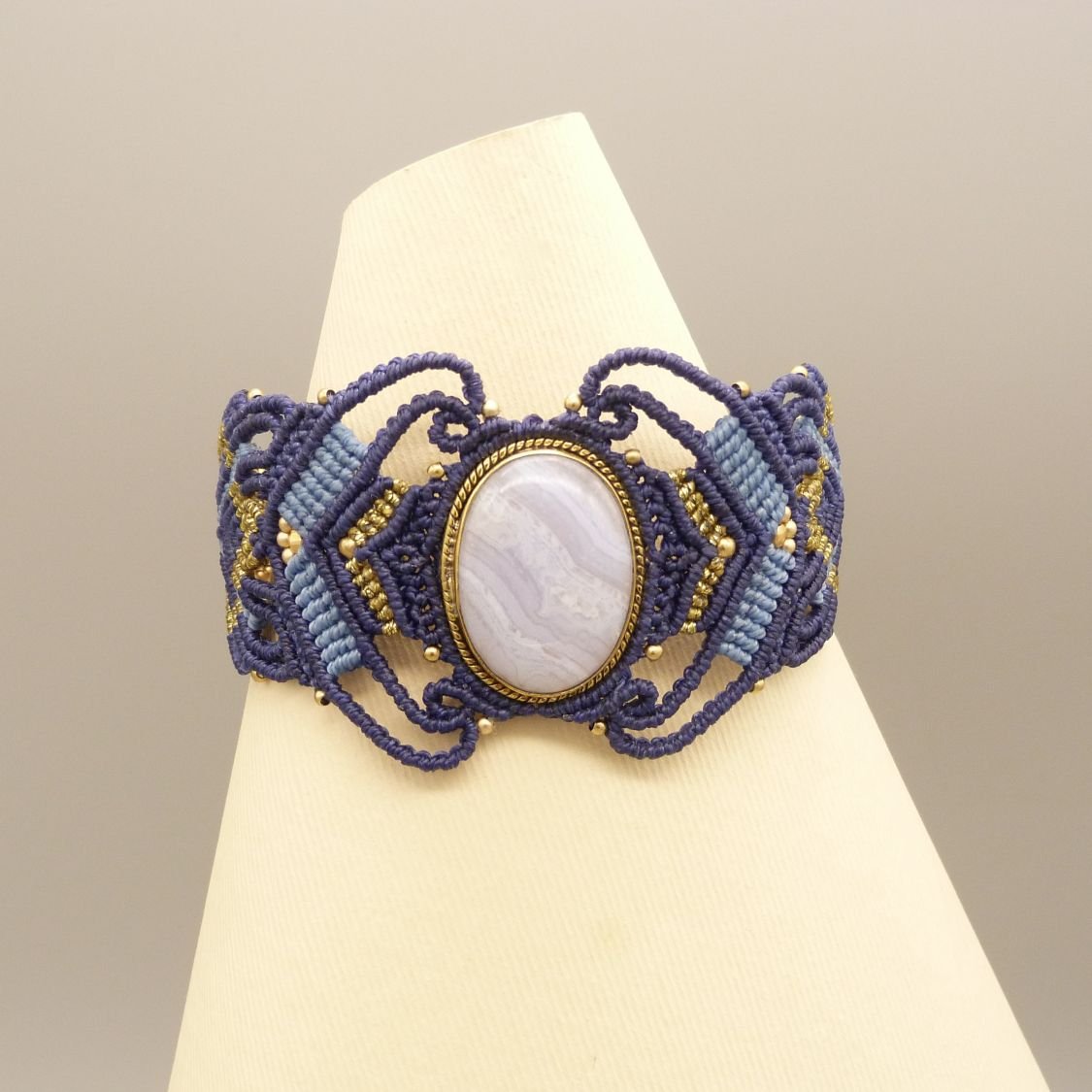 Midnight blue micro-macramé bracelet with a ribbon agate set in gold metal