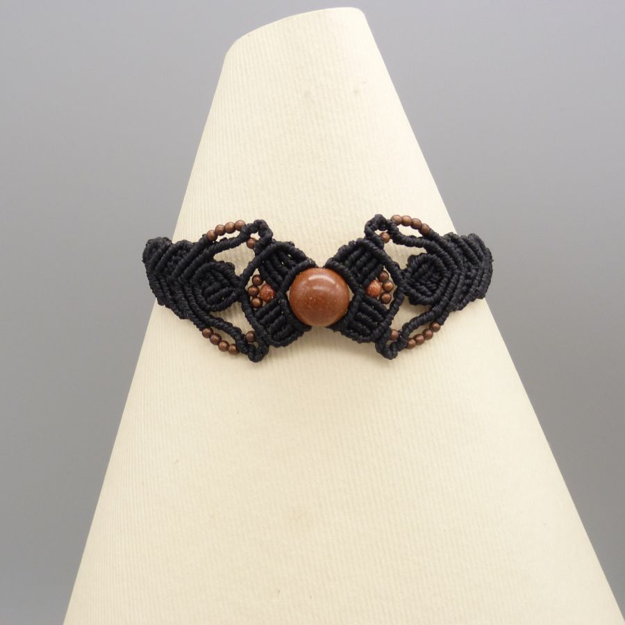 Black micro-macramé bracelet with a central "sun stone" bead