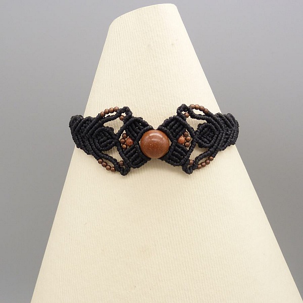 Black micro-macram&eacute; bracelet with a central "sun stone" bead