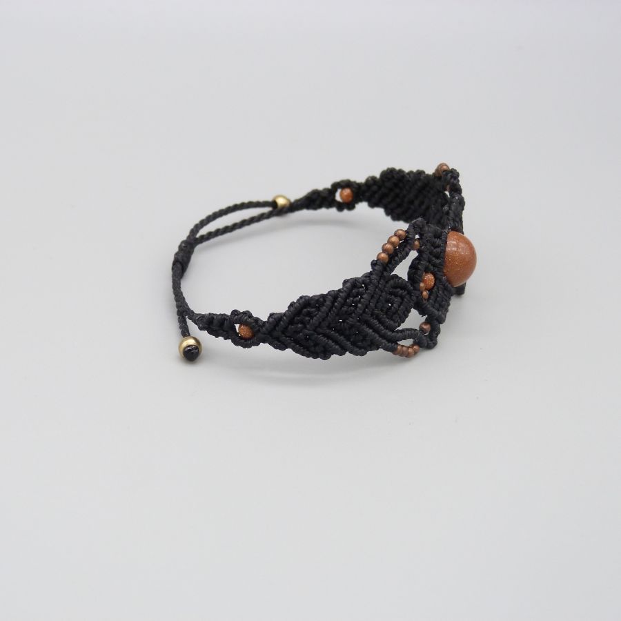 Black micro-macramé bracelet with a central "sun stone" bead