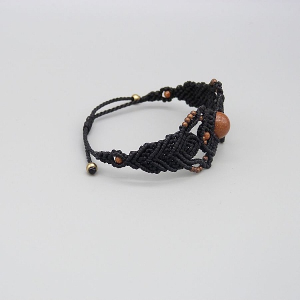 Black micro-macram&eacute; bracelet with a central "sun stone" bead