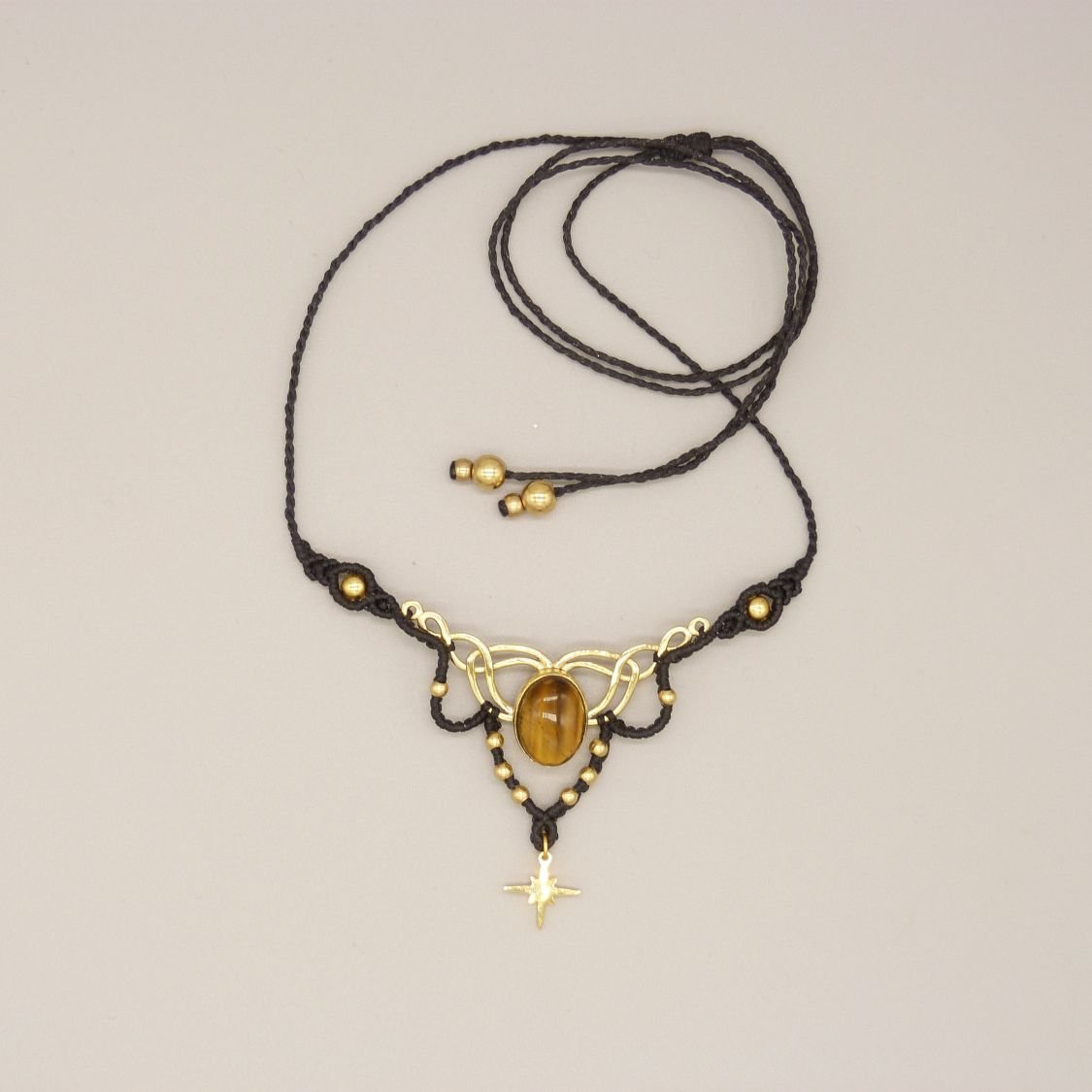 Black micro-macramé necklace with a tiger eye