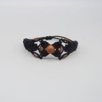 Black micro-macramé bracelet with a central 'sun stone' bead