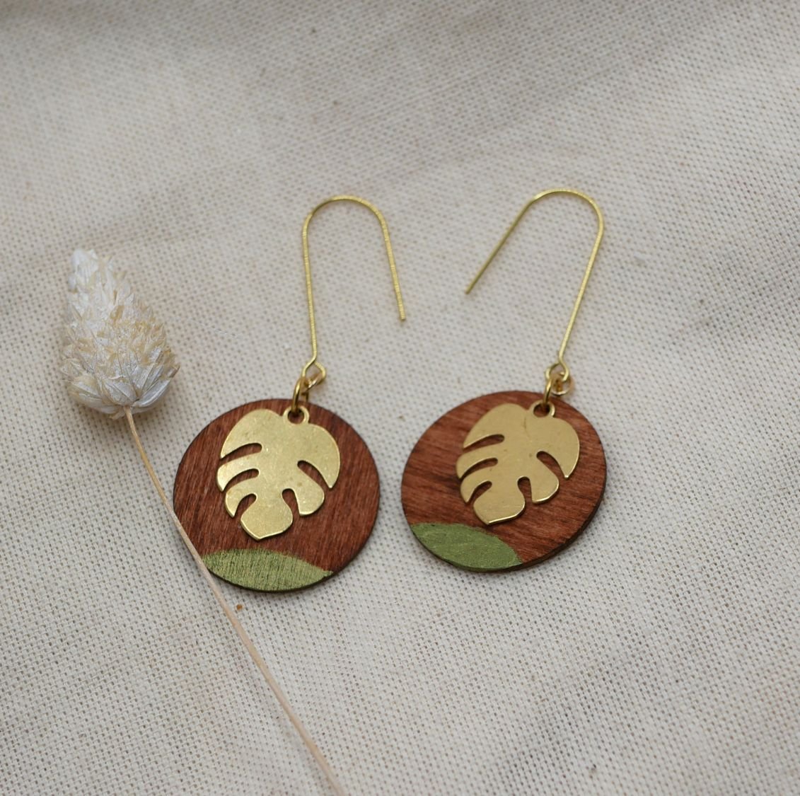 Cherry wood and monstera leaf earrings in gold plated brass