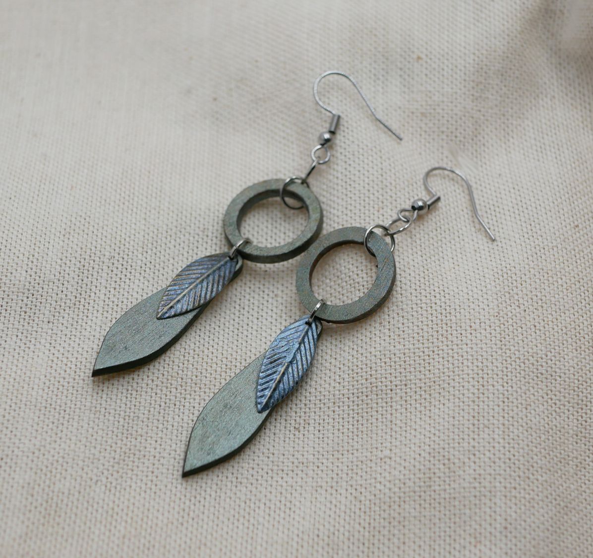 Leaf earrings made of wood and metal with a greenish-grey patina