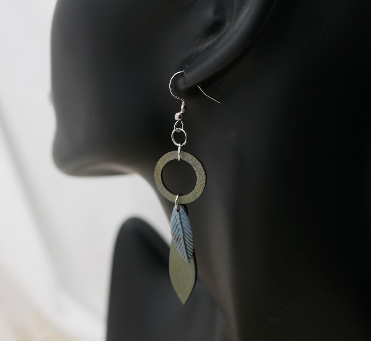 Leaf earrings made of wood and metal with a greenish-grey patina