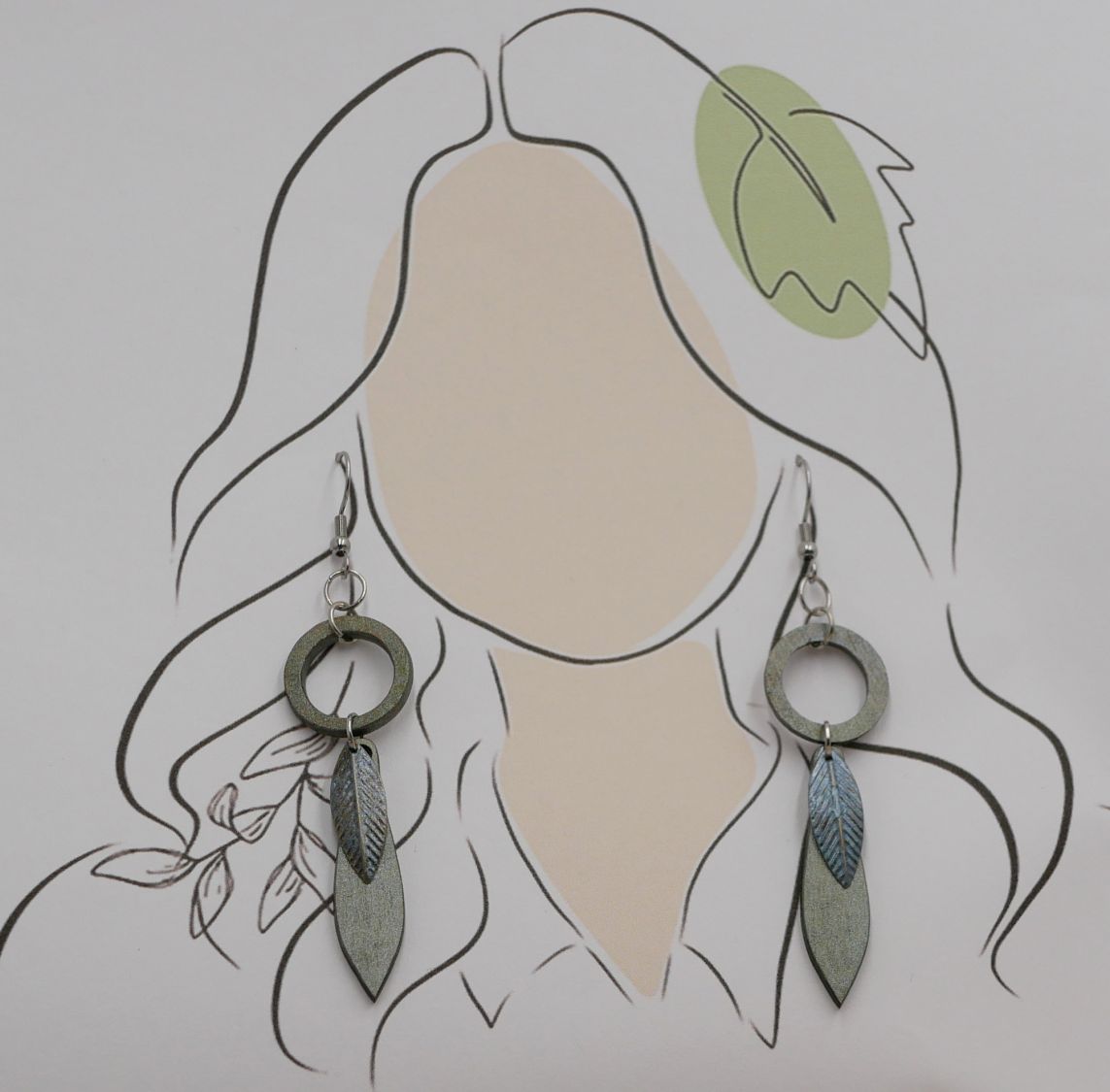 Leaf earrings made of wood and metal with a greenish-grey patina