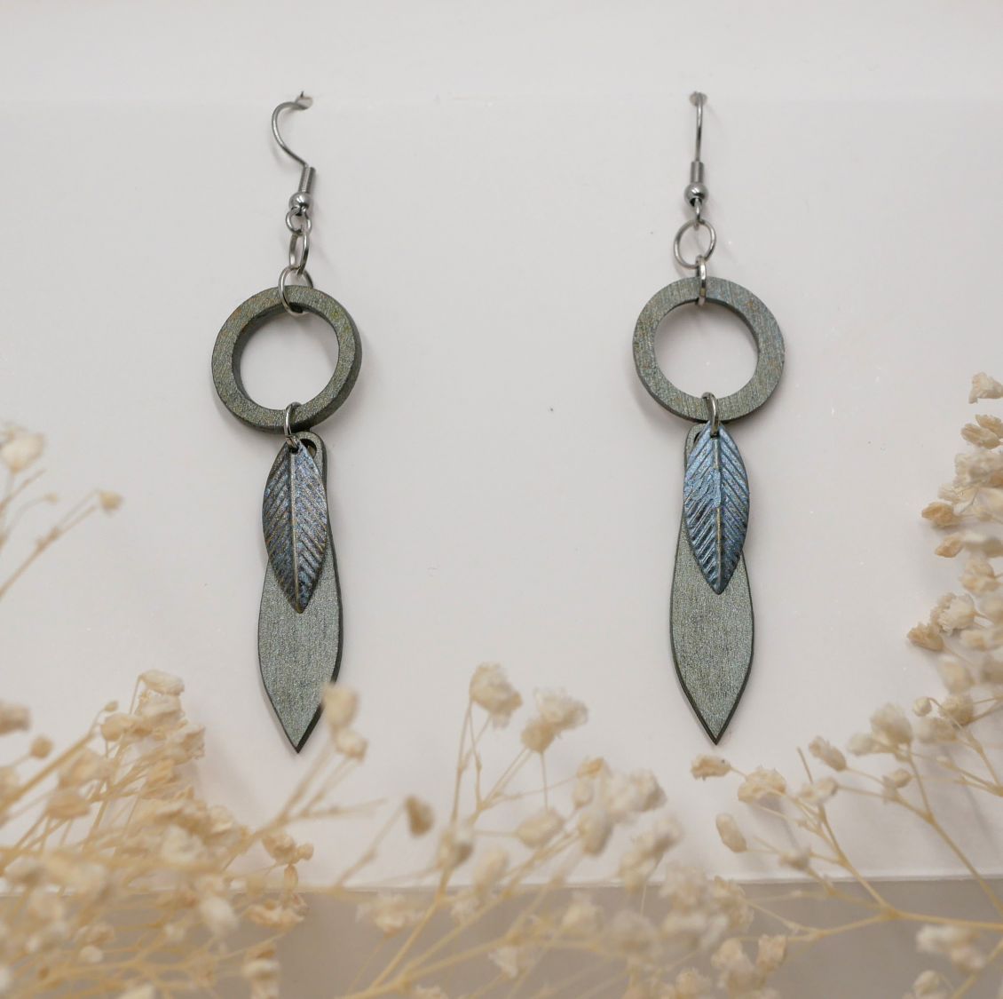 Leaf earrings made of wood and metal with a greenish-grey patina