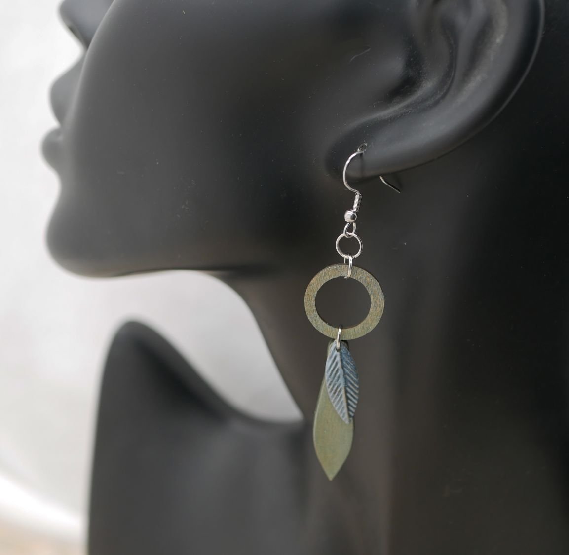 Leaf earrings made of wood and metal with a greenish-grey patina