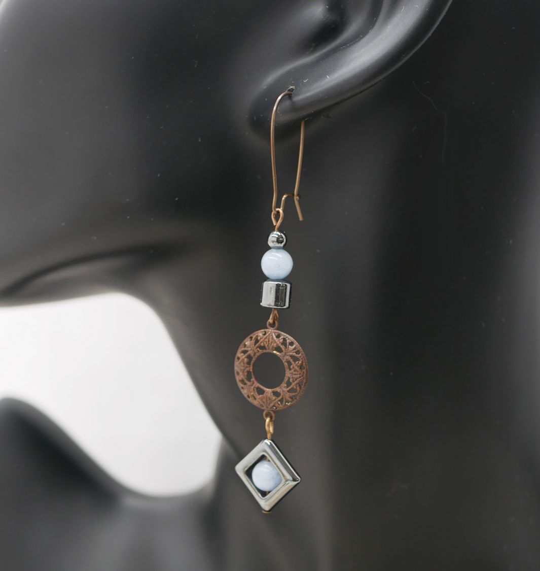 Asymmetrical earrings in natural brass and hematite beads