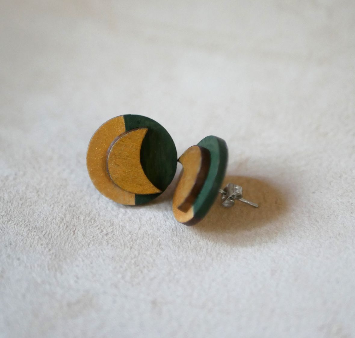 Round wooden earrings with moons in dark green and gold