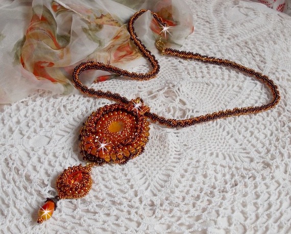 Lady in Orange pendant necklace is embroidered with Swarovski crystals, Miyuki seed beads and magic beads.