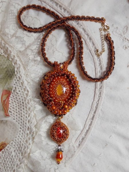 Lady in Orange pendant necklace is embroidered with Swarovski crystals, Miyuki seed beads and magic beads.