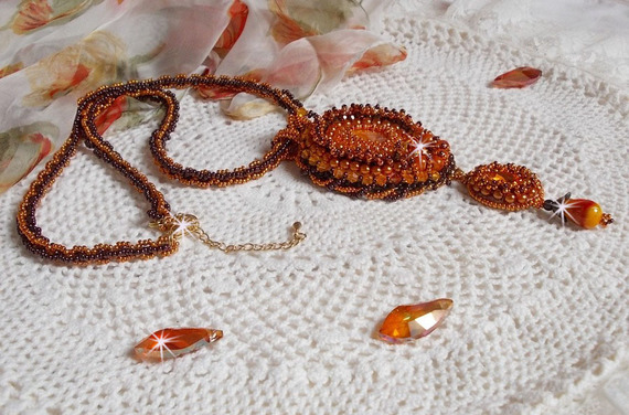 Lady in Orange pendant necklace is embroidered with Swarovski crystals, Miyuki seed beads and magic beads.