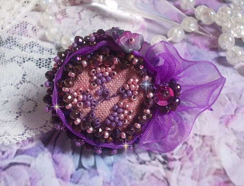 Romantic Lady Ring embroidered with on a pink linen fabric with Pink, Iris, Purple and Peach seed beads 
